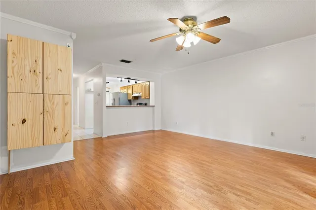 a view of a livingroom with a chandelier fan