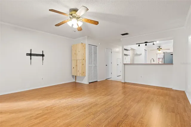 a view of a livingroom with a ceiling fan and window