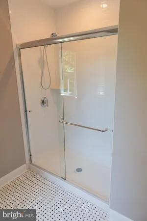 a bathroom with a glass shower door