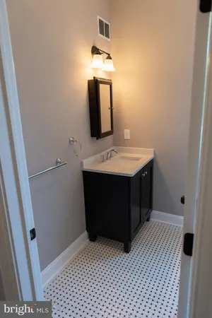a bathroom with a sink a vanity and a mirror