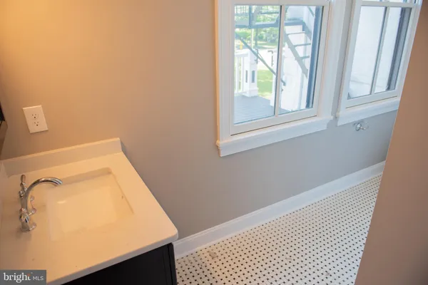 a bathroom with a bathtub and a window