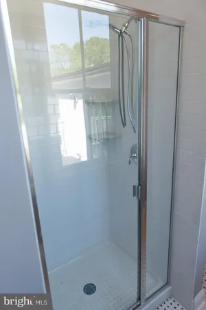 a bathroom with a glass shower door