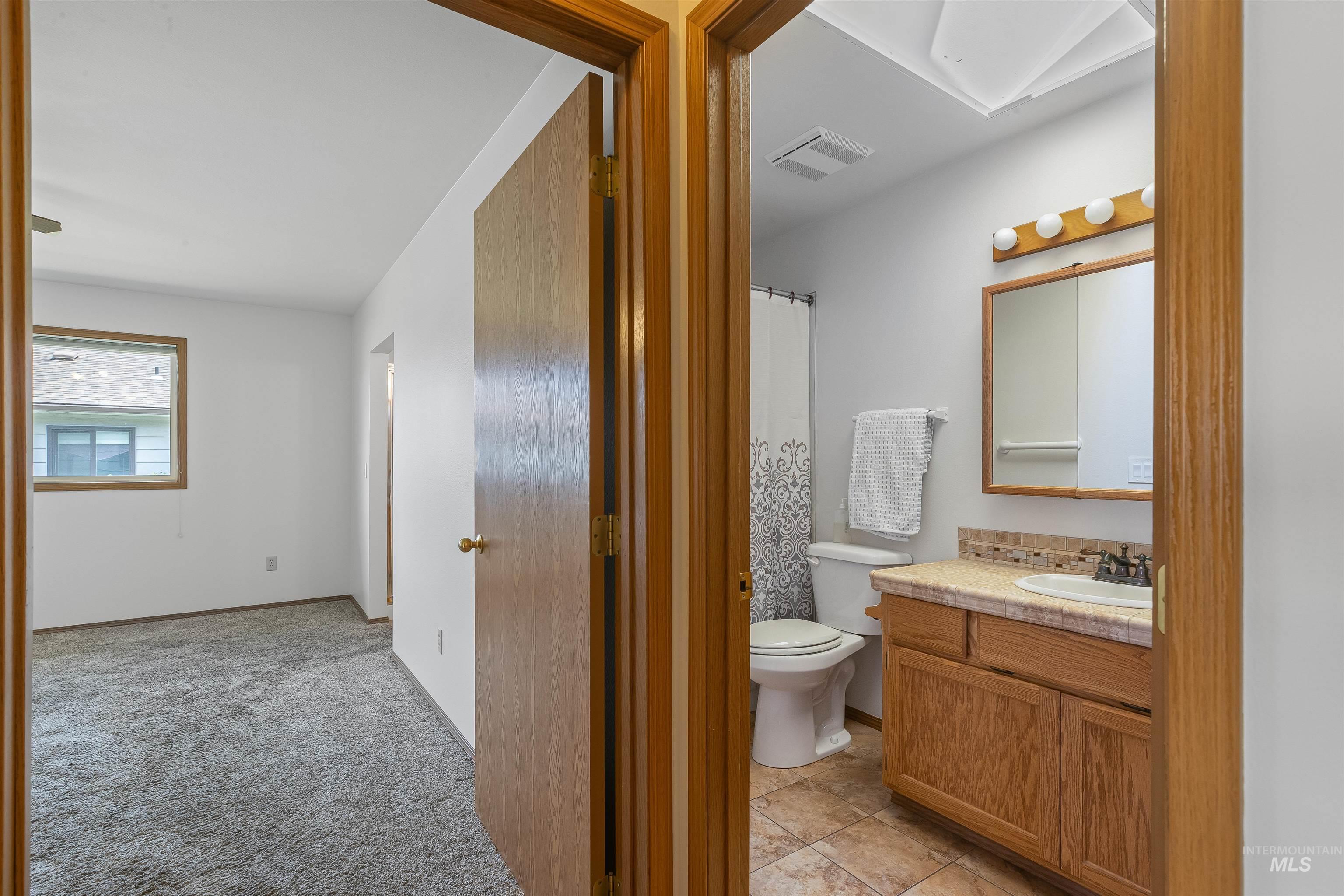 1409 29th Street Lewiston, ID 83501 - Photo 13 of 22 Full bath featuring vanity and a shower with shower curtain