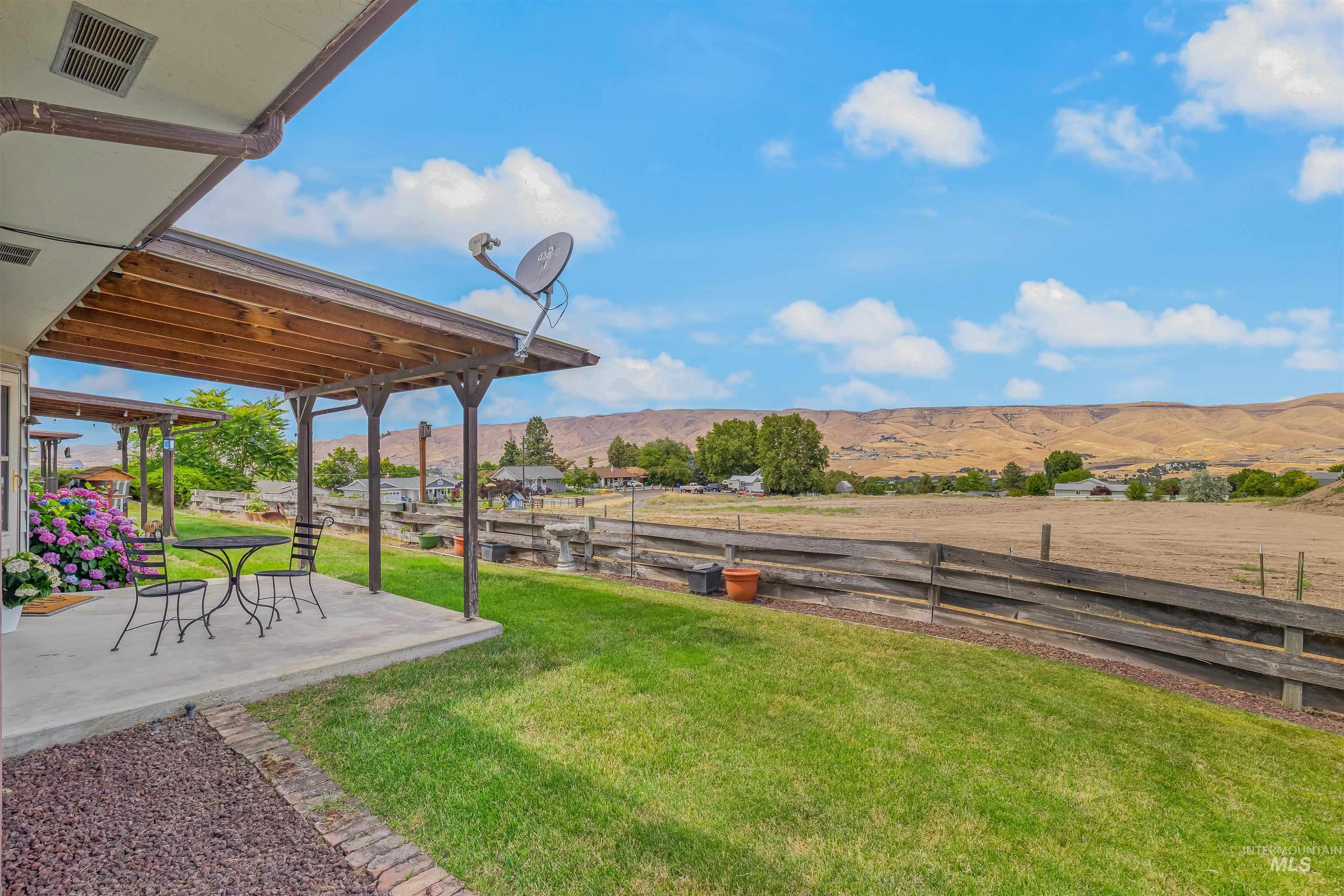 1409 29th Street Lewiston, ID 83501 - Photo 19 of 22 View of yard featuring a mountain view, a patio area, and a view of countryside