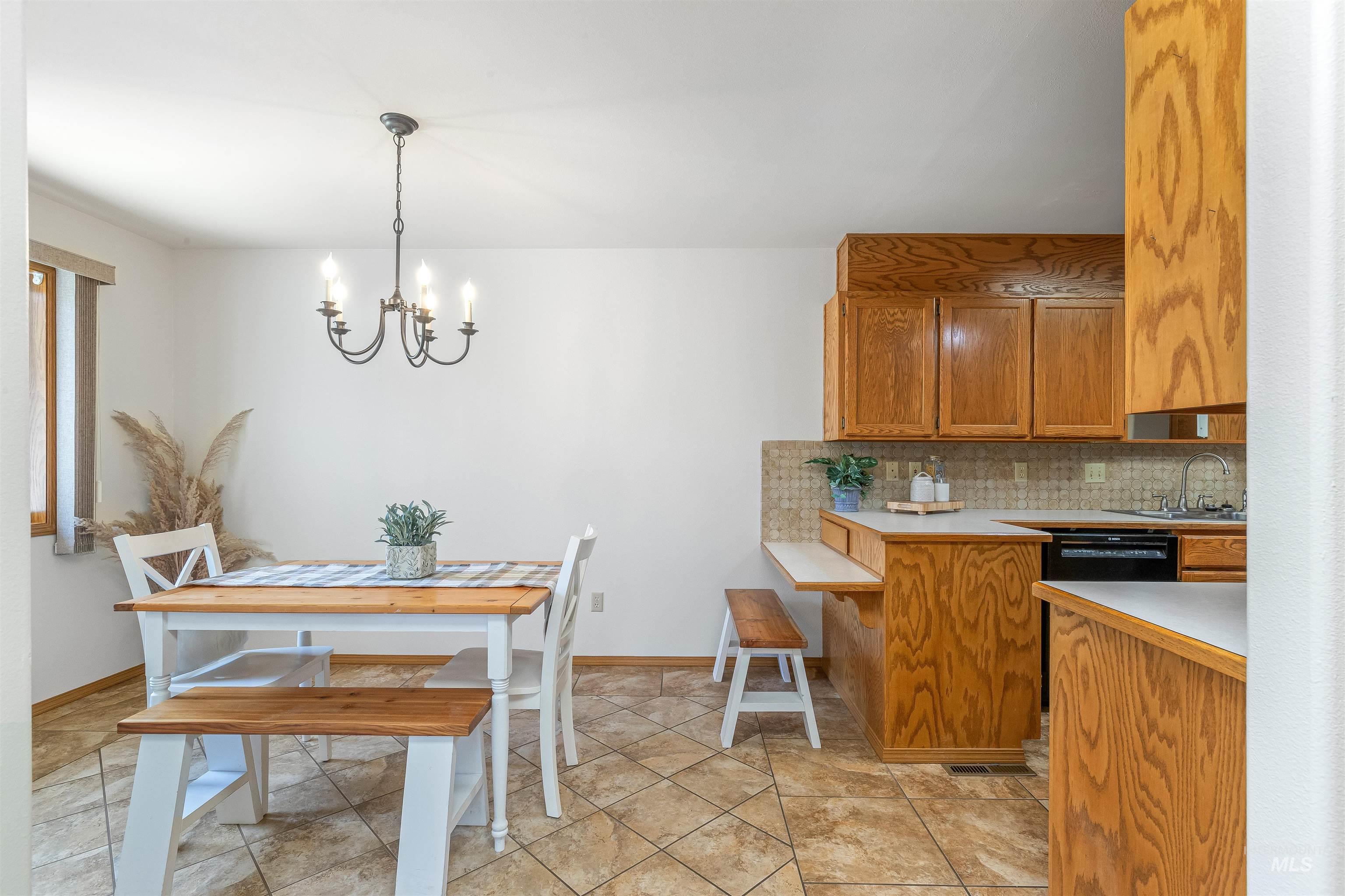 1409 29th Street Lewiston, ID 83501 - Photo 3 of 22 Dining room featuring a chandelier and light stone finish flooring