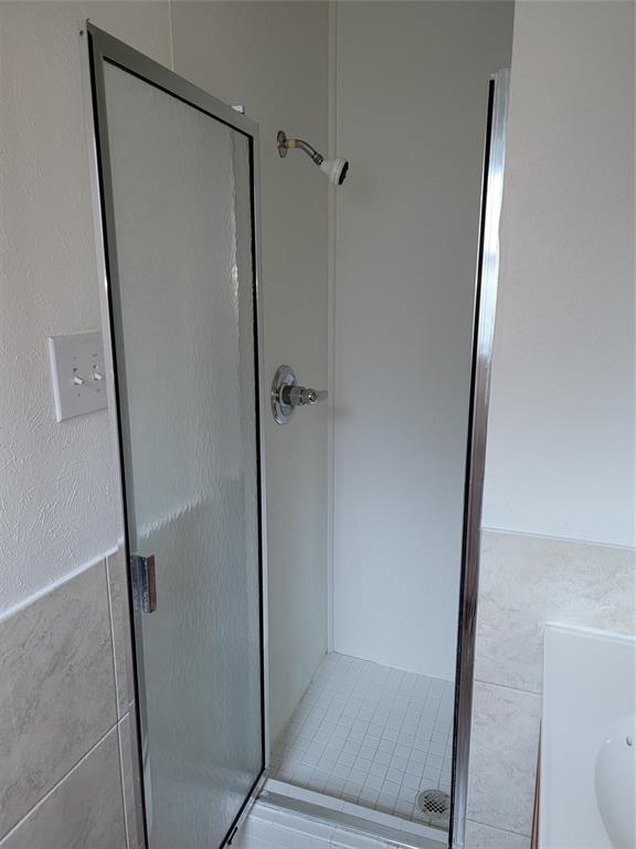 1000 Springdale Road Bedford, TX 76021 - Photo 18 of 36 Main bathroom's stall shower tucked behind the wall is longer than it looks--a must see in person!