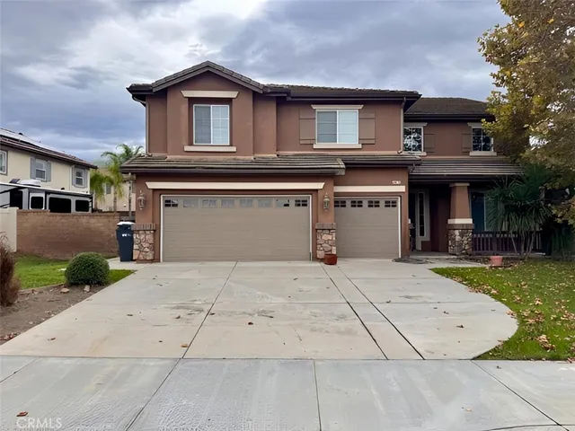 a front view of a house with a yard and a garage