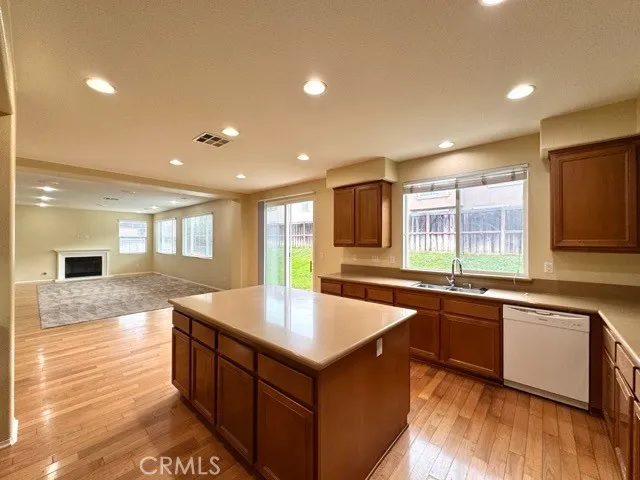 a kitchen with stainless steel appliances granite countertop a sink and a stove