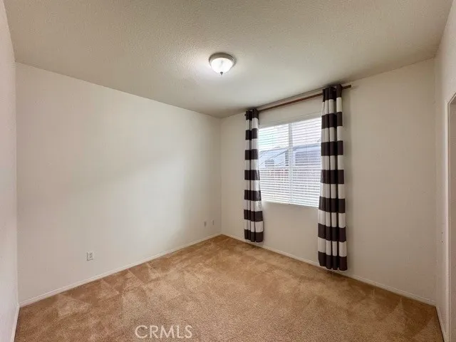 a view of empty room with closet