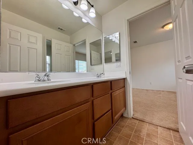 a bathroom with a double vanity sink and a mirror