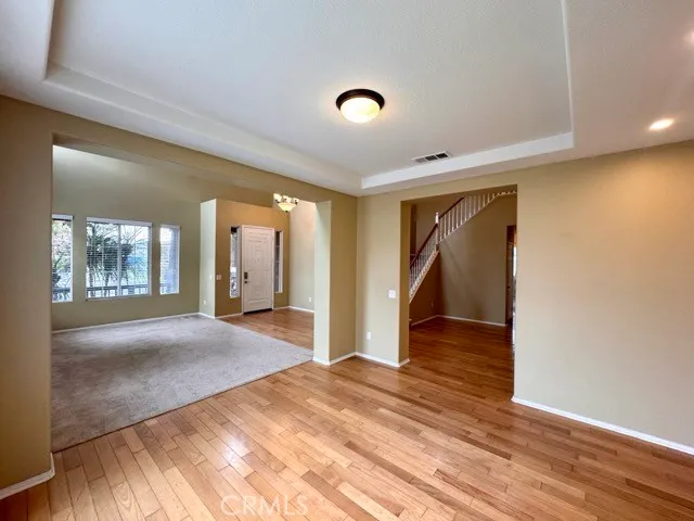 a view of a hallway with wooden floor and closet