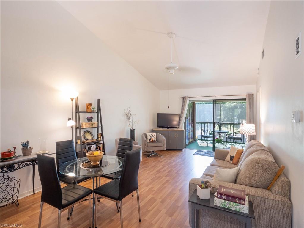 5857 Rattlesnake Hamm Road, Unit 204 Naples, FL 34113 - Photo 1 of 15 a living room with furniture and a flat screen tv