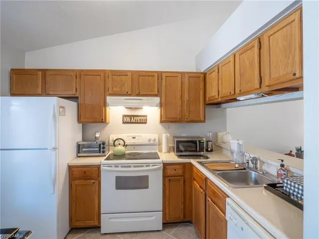 a kitchen with a sink cabinets and refrigerator