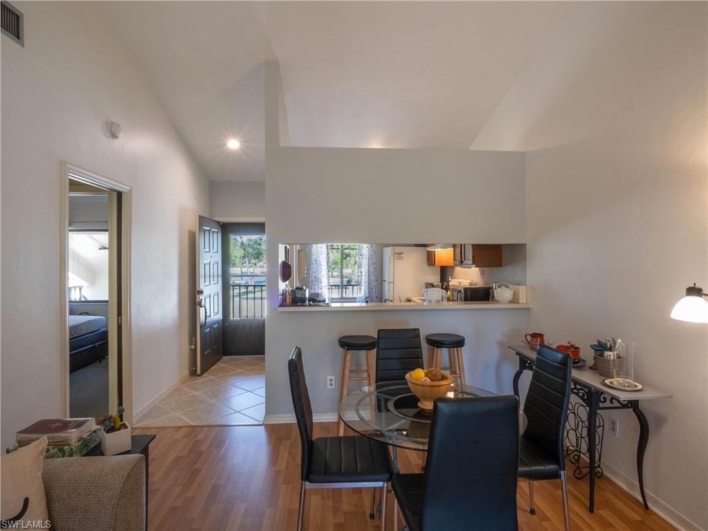 5857 Rattlesnake Hamm Road, Unit 204 Naples, FL 34113 - Photo 4 of 15 a dining room with furniture and window