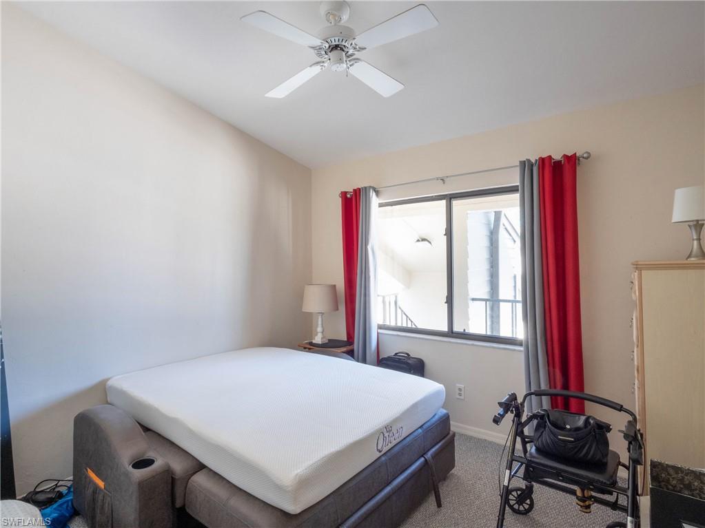 5857 Rattlesnake Hamm Road, Unit 204 Naples, FL 34113 - Photo 8 of 15 a bedroom with a bed and a window