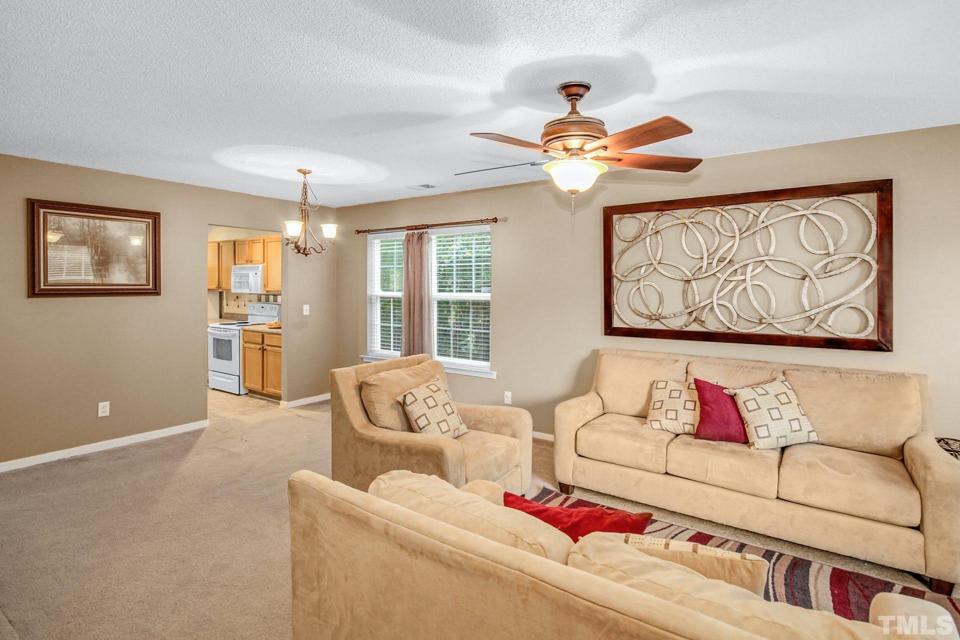 5925 Wessel Way Raleigh, NC 27610 - Photo 2 of 29 a living room with furniture and a chandelier