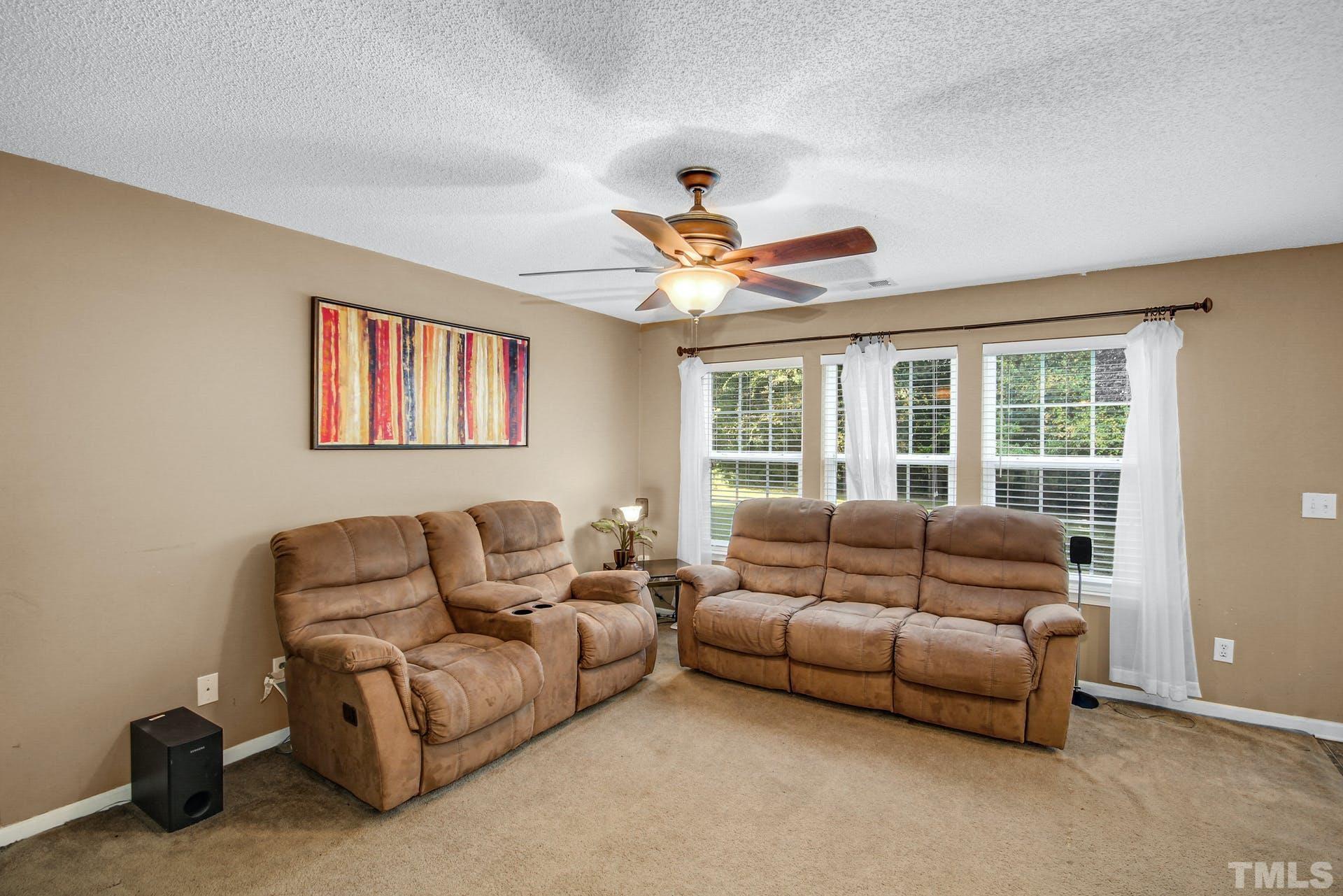 5925 Wessel Way Raleigh, NC 27610 - Photo 11 of 29 a living room with furniture ceiling fan and a window