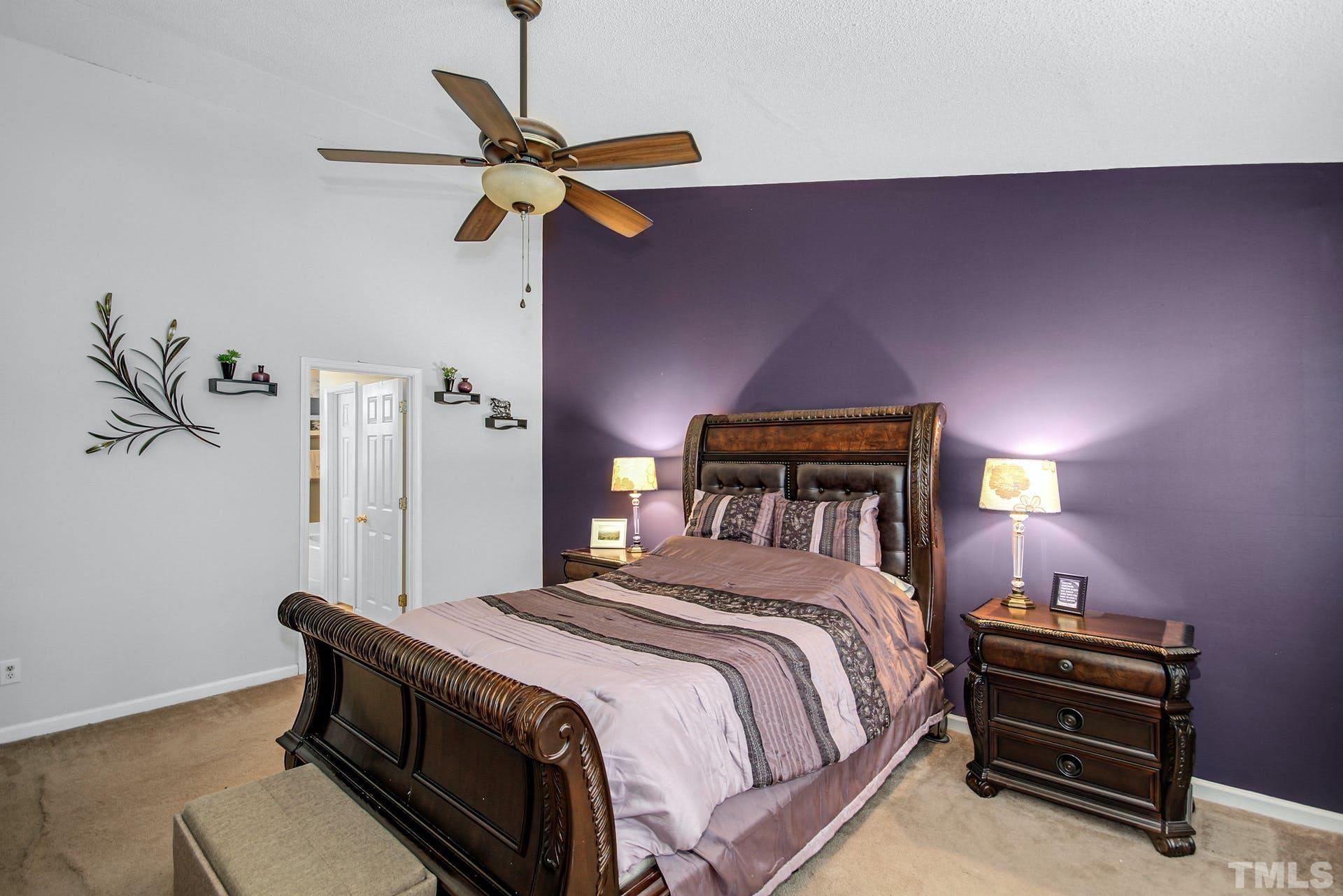 5925 Wessel Way Raleigh, NC 27610 - Photo 17 of 29 a bedroom with a bed a dresser and a potted plant