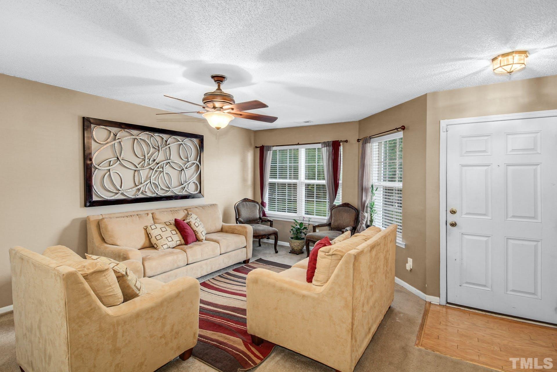 5925 Wessel Way Raleigh, NC 27610 - Photo 3 of 29 a living room with furniture ceiling fan and a window