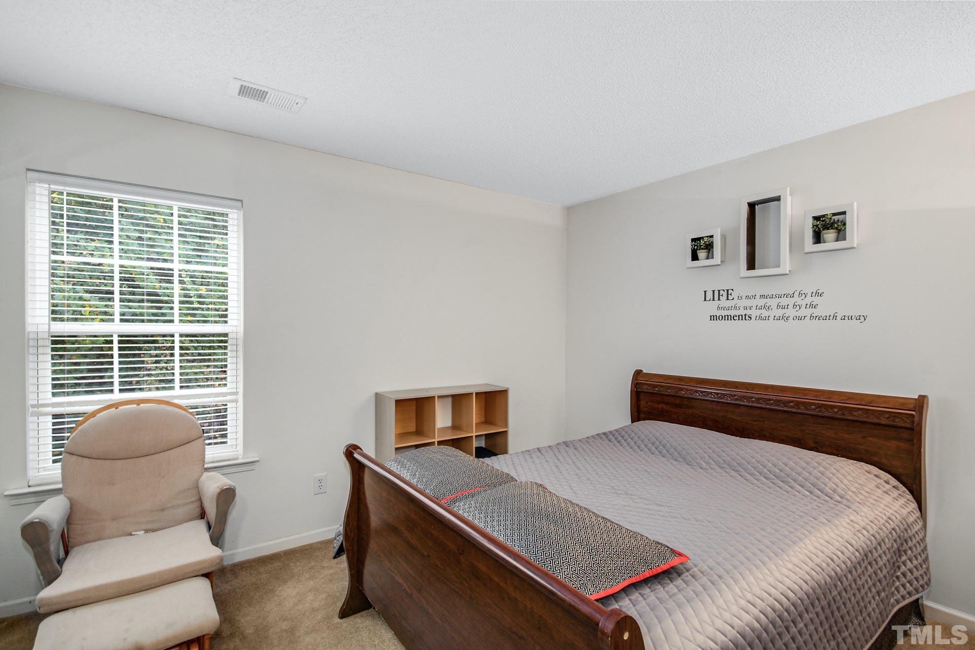 5925 Wessel Way Raleigh, NC 27610 - Photo 21 of 29 a bedroom with a bed and a window