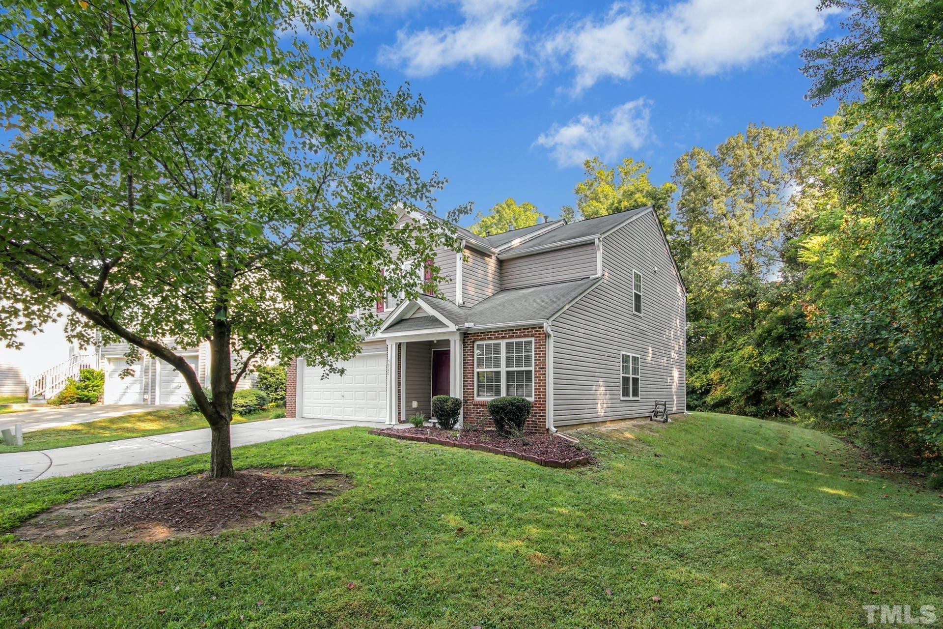 5925 Wessel Way Raleigh, NC 27610 - Photo 28 of 29 a front view of a house with a garden and tree