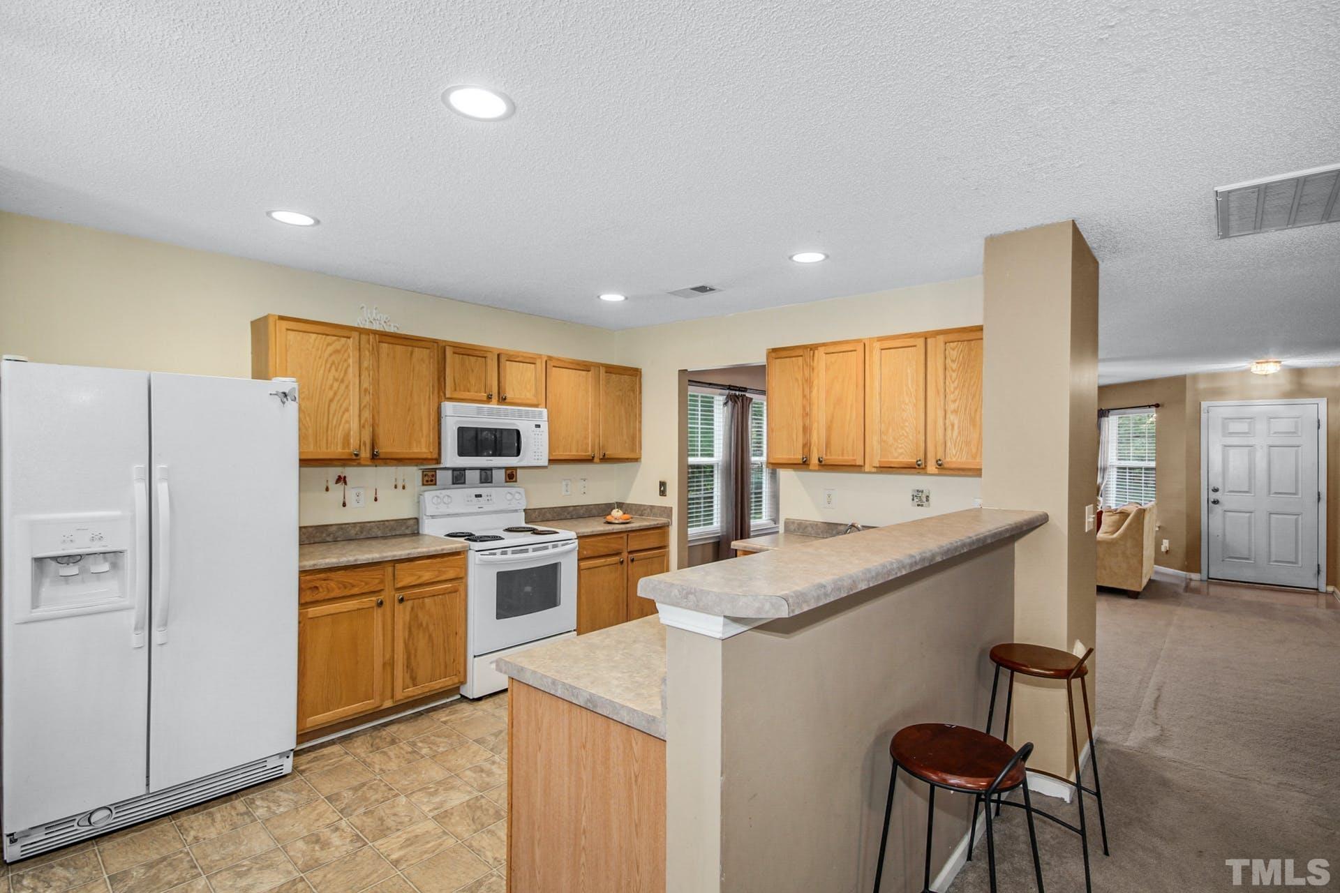 5925 Wessel Way Raleigh, NC 27610 - Photo 7 of 29 a kitchen with a sink a counter top stainless steel appliances and cabinets