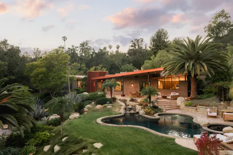 a view of swimming pool with outdoor seating and green space
