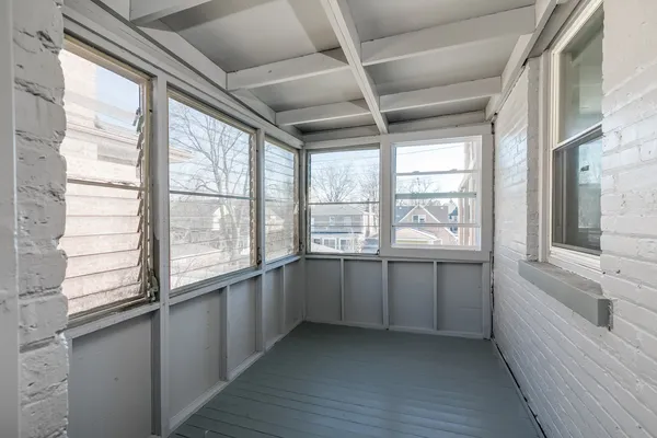 a large white kitchen with granite countertop a large window