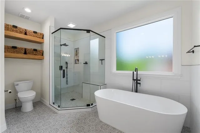 a bathroom with a bathtub and a shower
