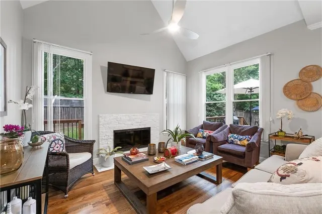 a living room with furniture fireplace and a large window