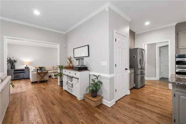 a kitchen with sink a refrigerator and white cabinets