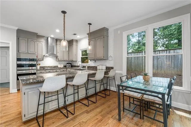 a dining room with furniture and wooden floor