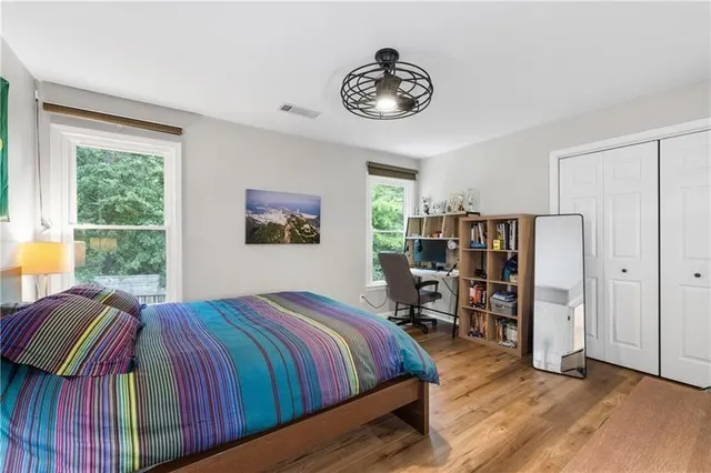 a bed sitting in a bedroom next to a window
