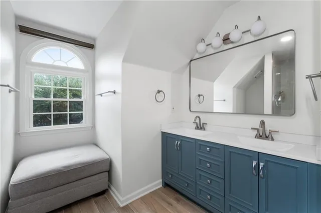 a en suite bathroom with a double vanity sink and a mirror