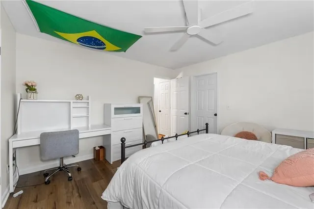 a bedroom with a bed and a desk