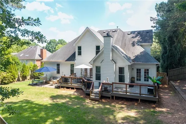 a view of a house with a yard and sitting area