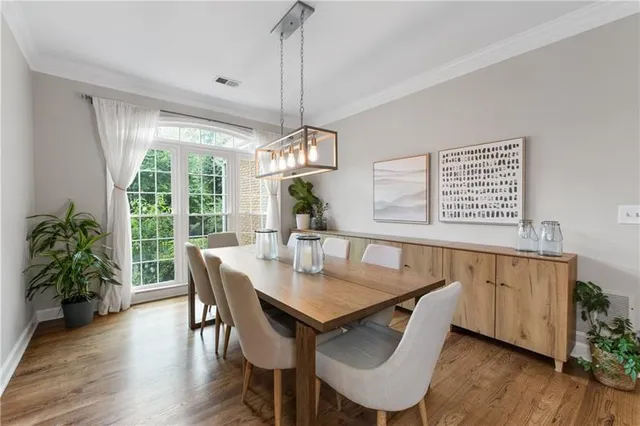 a view of a dining room with furniture window and wooden floor
