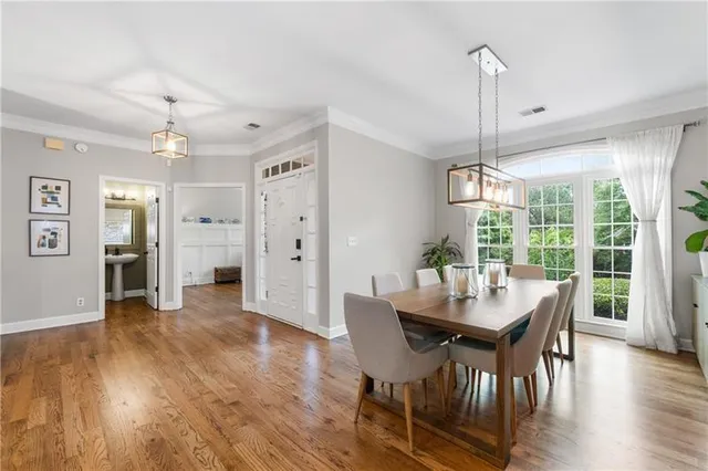 a view of a dining room with furniture window and wooden floor