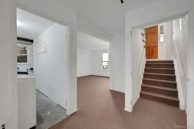 a view of a hallway with wooden floor and entryway