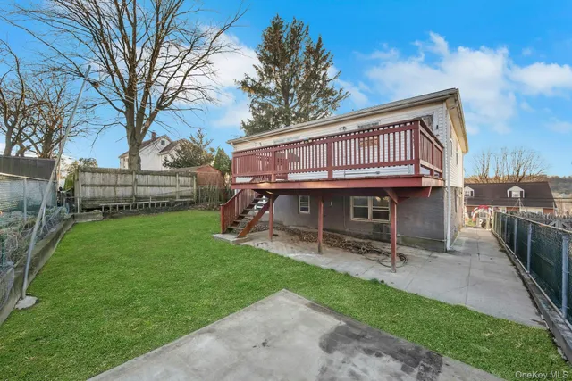 a view of backyard with a garden and deck