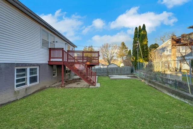 a view of a house with a backyard and a patio
