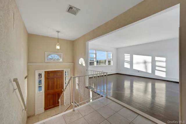 a view of a livingroom with wooden floor and a window
