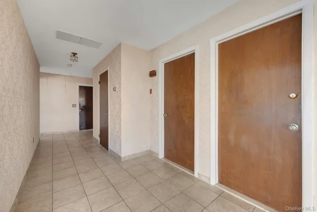a view of a livingroom with an empty space and a hallway