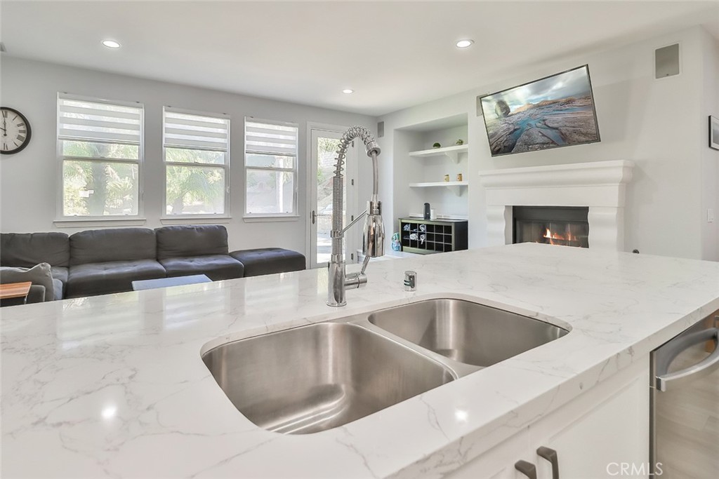 5421 Moonshadow Street Simi Valley, CA 93063 - Photo 22 of 56 a kitchen with a sink large window and cabinets