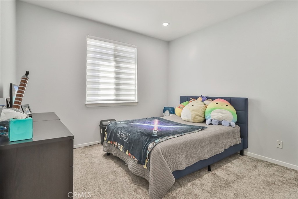 5421 Moonshadow Street Simi Valley, CA 93063 - Photo 32 of 56 a bedroom with a bed and a window