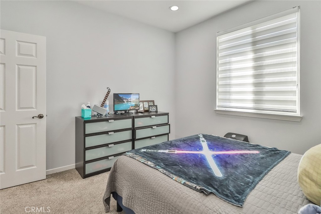 5421 Moonshadow Street Simi Valley, CA 93063 - Photo 33 of 56 a bedroom with a bed and window