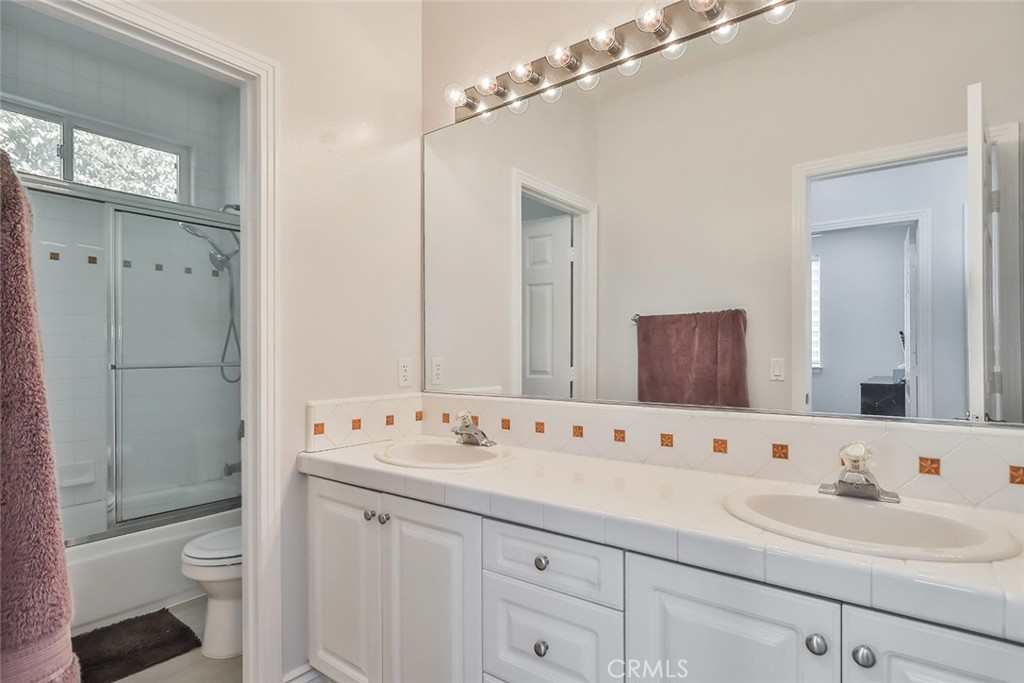 5421 Moonshadow Street Simi Valley, CA 93063 - Photo 34 of 56 a bathroom with a sink a toilet and shower