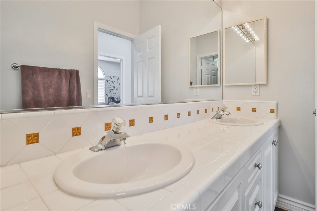 5421 Moonshadow Street Simi Valley, CA 93063 - Photo 35 of 56 a bathroom with a sink and a mirror