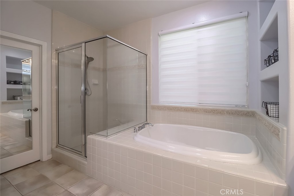 5421 Moonshadow Street Simi Valley, CA 93063 - Photo 42 of 56 a bathroom with a bathtub and a shower