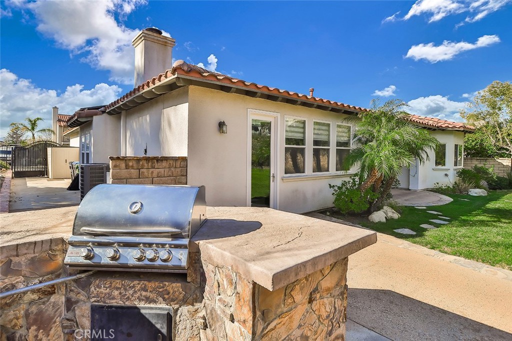 5421 Moonshadow Street Simi Valley, CA 93063 - Photo 45 of 56 a view of a white house with a yard
